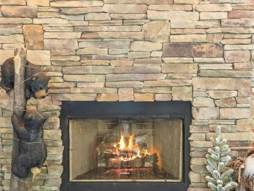 129 Apple Farm Road, Bakersville, NC 28705.  MLS# CAR4375301, YatesRealty ID 20926. Fireplace in Sunroom