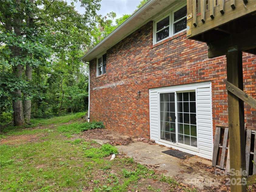 244 Mcmahan Lane, Bakersville, NC 28705.  MLS# CAR4269540, YatesRealty ID 20927. Rear of the house showing sliding glass doors