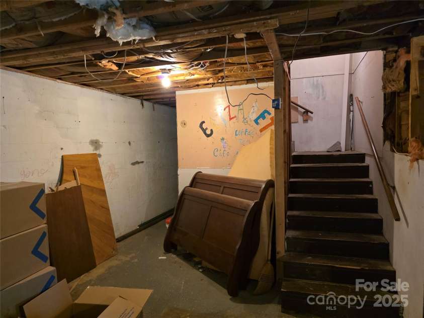 244 Mcmahan Lane, Bakersville, NC 28705.  MLS# CAR4269540, YatesRealty ID 20927. Stairway from the basement to main floor