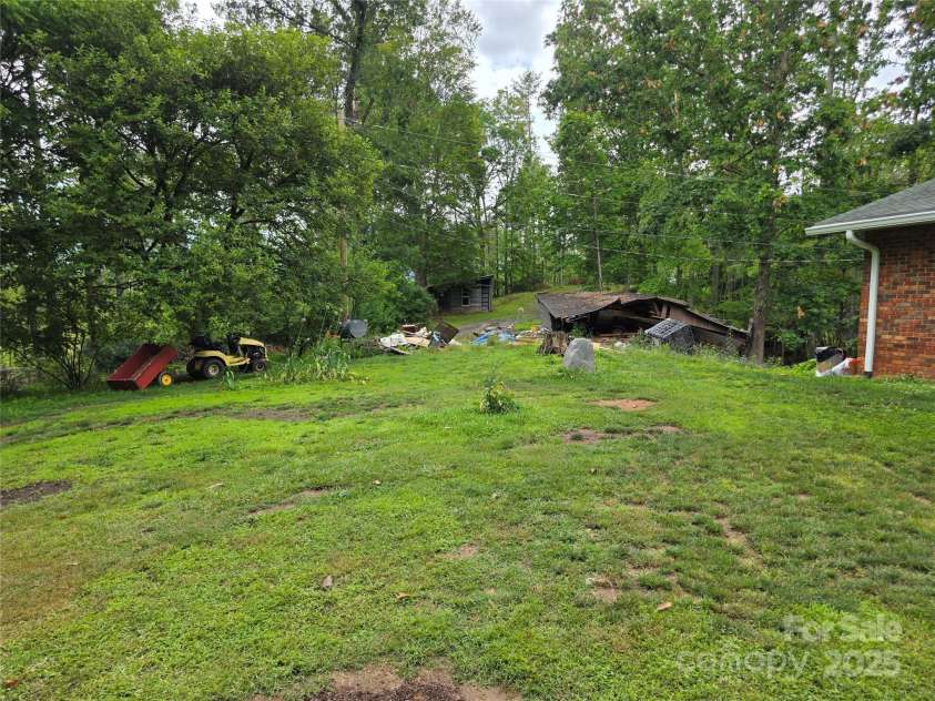 244 Mcmahan Lane, Bakersville, NC 28705.  MLS# CAR4269540, YatesRealty ID 20927. View looking east across the front lawn