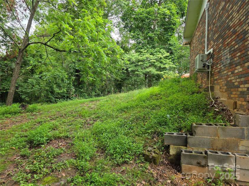 244 Mcmahan Lane, Bakersville, NC 28705.  MLS# CAR4269540, YatesRealty ID 20927. View of lawn on west end of house