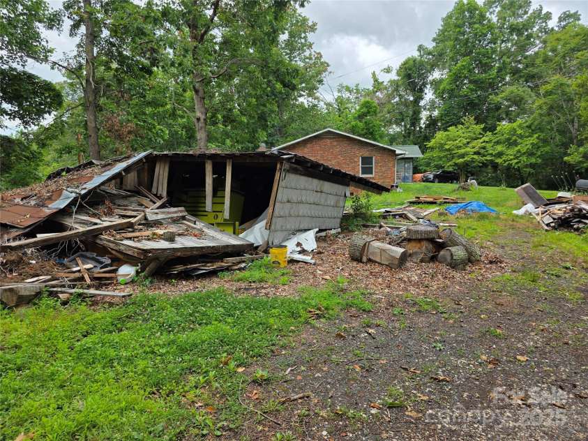 244 Mcmahan Lane, Bakersville, NC 28705.  MLS# CAR4269540, YatesRealty ID 20927. Wreckage of outbuilding after Helene blew 6 trees down on it