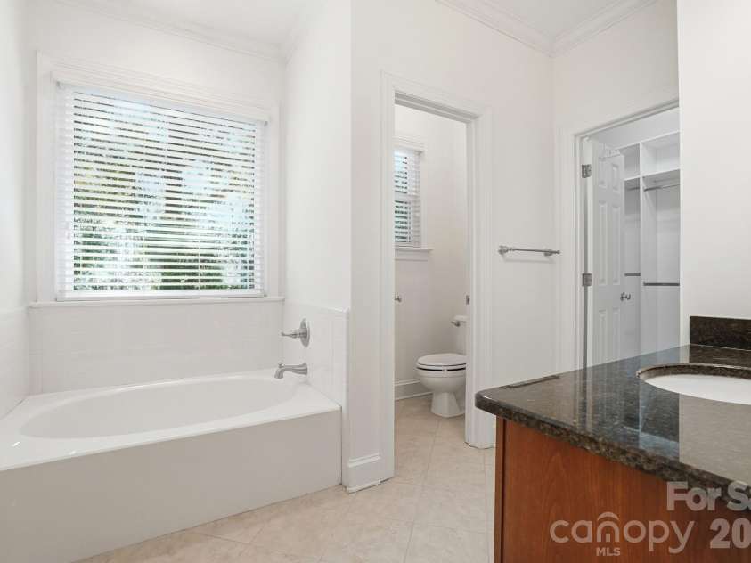 8044 Hawk Crest Court, Charlotte, NC 28270.  MLS# CAR4267919, YatesRealty ID 20940. Garden tub with tile surround, private water closet and walk in closet