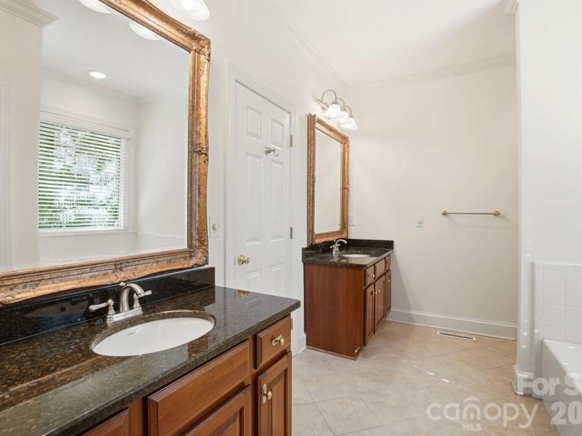 8044 Hawk Crest Court, Charlotte, NC 28270.  MLS# CAR4267919, YatesRealty ID 20940. Owners bath on main level, dual sinks, tile flooring, walk in closet with closet system