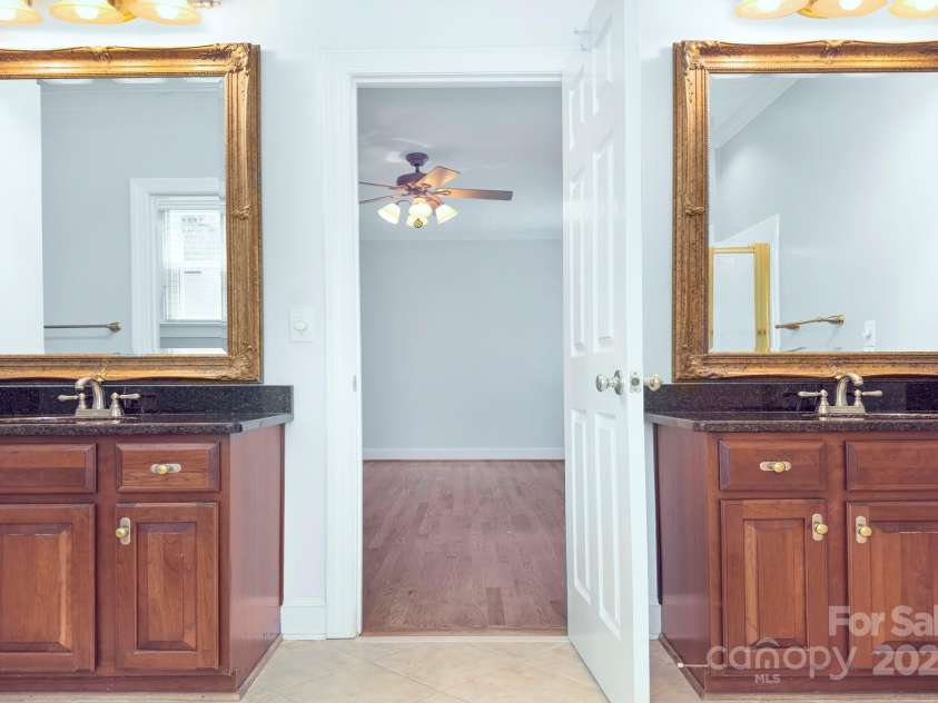 8044 Hawk Crest Court, Charlotte, NC 28270.  MLS# CAR4267919, YatesRealty ID 20940. Primary bath with dual vanities, granite counters, framed mirrors