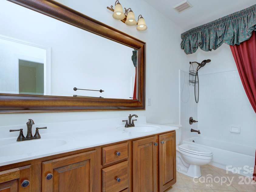 8044 Hawk Crest Court, Charlotte, NC 28270.  MLS# CAR4267919, YatesRealty ID 20940. Upstairs full bathroom- dual sinks, framed mirror and tub/shower combo