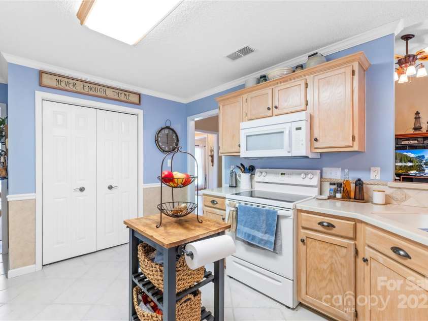 4313 Wynborough Lane, Charlotte, NC 28269.  MLS# CAR4271807, YatesRealty ID 20945. Kitchen has pantry closet, white appliances only 10 years old. Upgraded cabinets with pull outs and new stain.