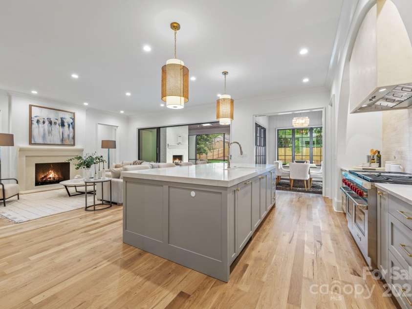 5124 Lansing Drive, Charlotte, NC 28270.  MLS# CAR4231364, YatesRealty ID 20951. Custom cabinetry and large island with views of the Breakfast Room and out through the multi slide doors to the screen porch.