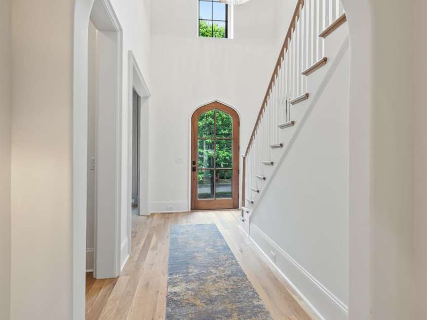 5124 Lansing Drive, Charlotte, NC 28270.  MLS# CAR4231364, YatesRealty ID 20951. Hallway leading to the front foyer.  Doorway on the left leads to the powder room.
