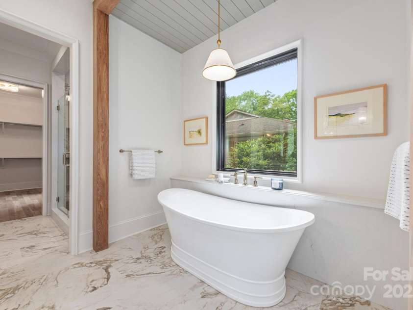 5124 Lansing Drive, Charlotte, NC 28270.  MLS# CAR4231364, YatesRealty ID 20951. Primary bath with oversized soaking tub and shower looking into the closet.