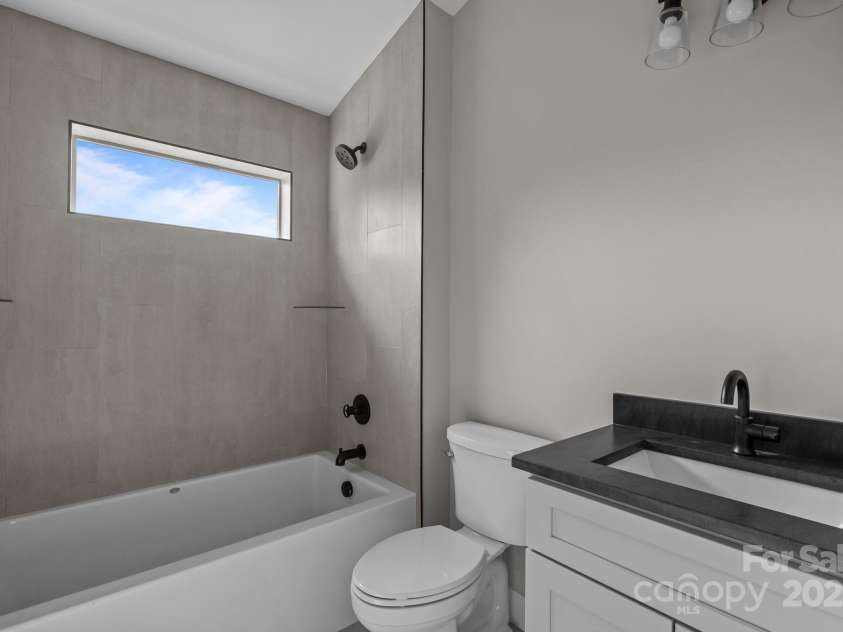 32 Woodrow Avenue, Asheville, NC 28801.  MLS# CAR4267388, YatesRealty ID 20969. Hall bath upstairs has a soaking tub