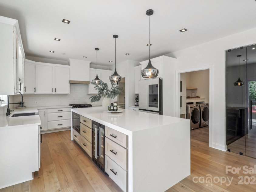 545 Morrison Farm Road, Troutman, NC 28166.  MLS# CAR4314529, YatesRealty ID 20985. 10 foot quartz island with beverage refrigerator and microwave