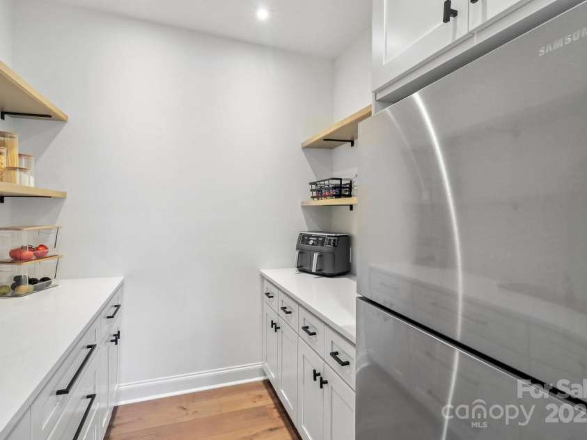 545 Morrison Farm Road, Troutman, NC 28166.  MLS# CAR4314529, YatesRealty ID 20985. Butlers pantry with storage and a second refrigerator