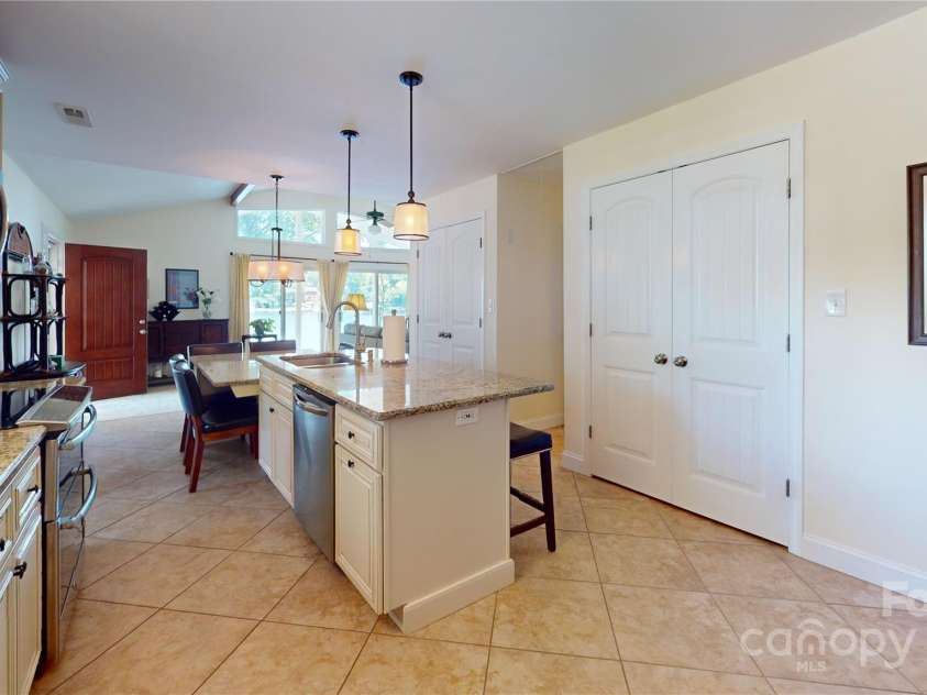 114 Caraway Lane, Mooresville, NC 28117.  MLS# CAR4268740, YatesRealty ID 20994. Pantry and additional storage closets flank hallway to central guest bath and bedroom 2 ensuite.