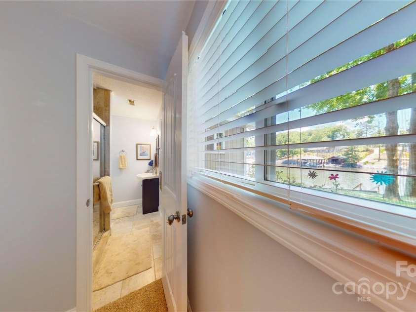 114 Caraway Lane, Mooresville, NC 28117.  MLS# CAR4268740, YatesRealty ID 20994. Peak view of bedroom 2's private bath. Views out window of water.