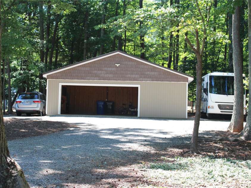 114 Caraway Lane, Mooresville, NC 28117.  MLS# CAR4268740, YatesRealty ID 20994. RV cement parking pad and vehicle parking flank garage.