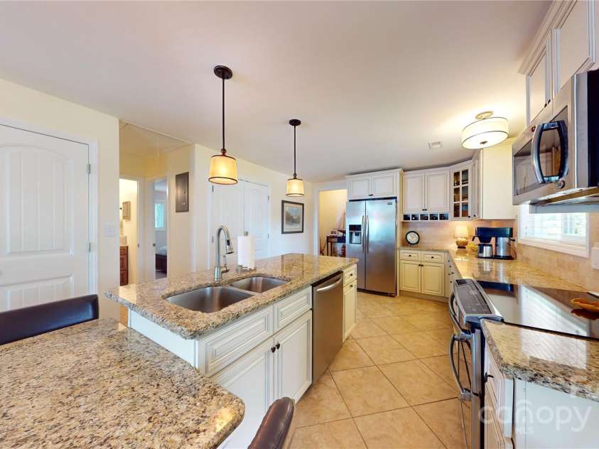 114 Caraway Lane, Mooresville, NC 28117.  MLS# CAR4268740, YatesRealty ID 20994. View across kitchen toward back hallway.