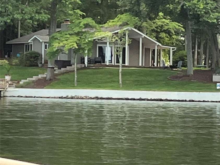 114 Caraway Lane, Mooresville, NC 28117.  MLS# CAR4268740, YatesRealty ID 20994. View from lake toward home.