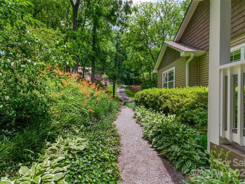 209 Blink Bonny Drive, Waynesville, NC 28786.  MLS# CAR4260662, YatesRealty ID 21001. Beautiful landscaping and walking path