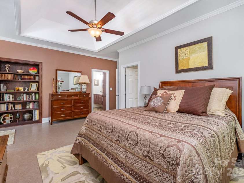 345 Beaten Path Road, Mooresville, NC 28117.  MLS# CAR4269577, YatesRealty ID 21006. Primary suite features built in shelves, tray ceiling, two walk in closets and large remodeled bathroom.