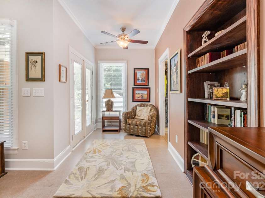 345 Beaten Path Road, Mooresville, NC 28117.  MLS# CAR4269577, YatesRealty ID 21006. Sitting area in primary suite with doors that lead out to the covered porch