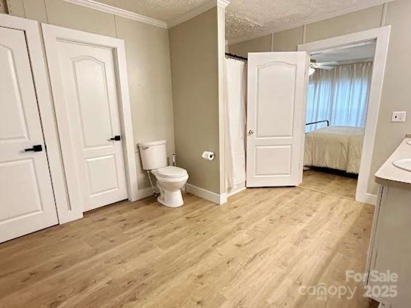 176 Browntown Road, Millers Creek, NC 28651.  MLS# CAR4199942, YatesRealty ID 21010. Bathroom with primary bedroom