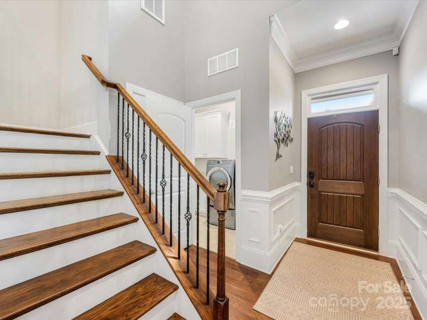 5030 Waldron Meadow Drive, Charlotte, NC 28226.  MLS# CAR4261235, YatesRealty ID 21019. Inviting Entry w/ Laundry, coat closet and Wood Steps with wrought iron balusters