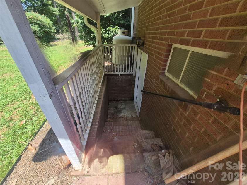 215 Biscoe Road, Troy, NC 27371.  MLS# CAR4346289, YatesRealty ID 2102. Basement Stairs - Outdoor Access