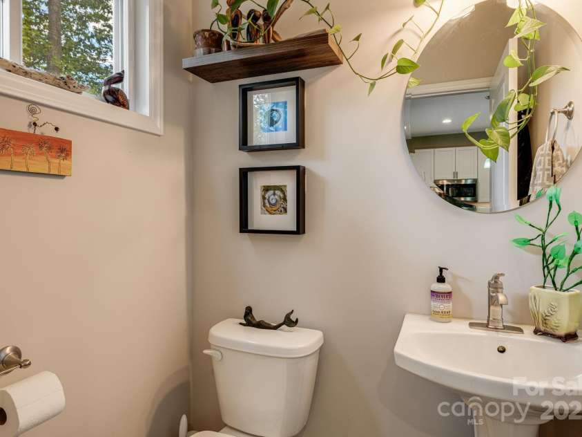 19 Shadowlawn Drive, Asheville, NC 28806.  MLS# CAR4258649, YatesRealty ID 21020. Half bath on main level with pedestal sink and modern mirror