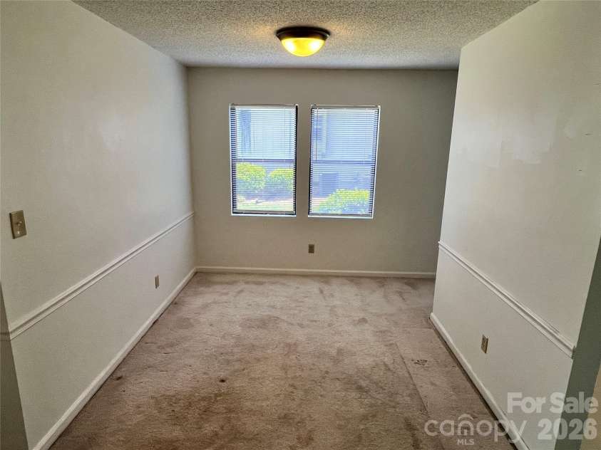 2401 Abbey Circle, Asheville, NC 28805.  MLS# CAR4379167, YatesRealty ID 21020. Dining room with large outside space between units.