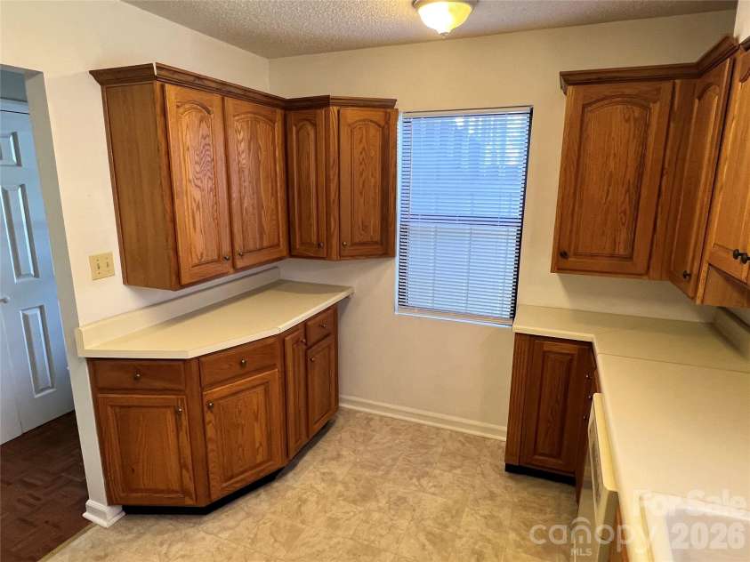 2401 Abbey Circle, Asheville, NC 28805.  MLS# CAR4379167, YatesRealty ID 21020. Updated kitchen cabinets and extra space on one side.