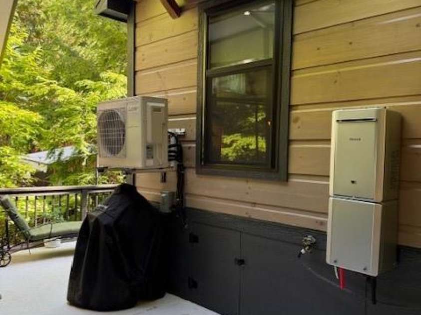 26 Cumberland Drive, Lake Toxaway, NC 28747.  MLS# CAR4262953, YatesRealty ID 21021. Back of home with tankless water heater