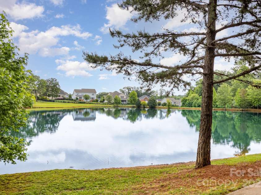8709 Raven Top Drive, Mint Hill, NC 28227.  MLS# CAR4263622, YatesRealty ID 21023. Community greenspace and pond