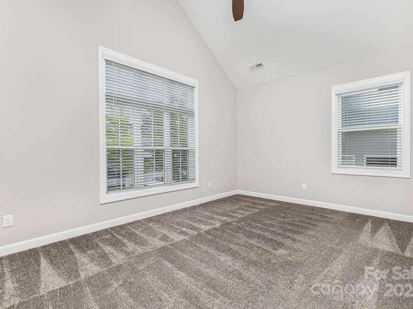 8709 Raven Top Drive, Mint Hill, NC 28227.  MLS# CAR4263622, YatesRealty ID 21023. Main-level second bedroom with vaulted ceiling