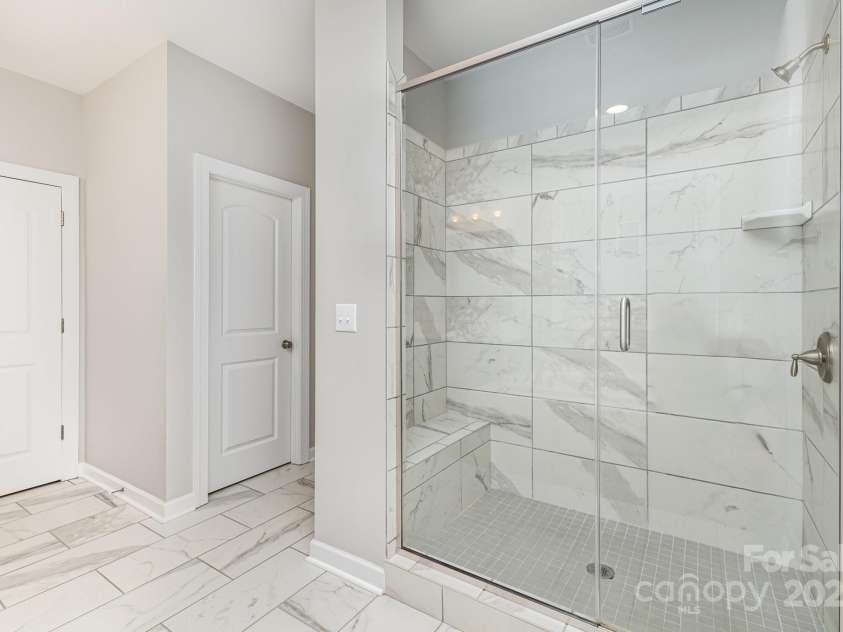 8709 Raven Top Drive, Mint Hill, NC 28227.  MLS# CAR4263622, YatesRealty ID 21023. Primary ensuite with large semi-frameless shower with large tile