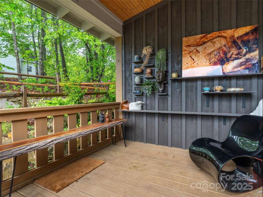15 Fay Jones Lane, Black Mountain, NC 28711.  MLS# CAR4259163, YatesRealty ID 21038. Front porch with custom shelving.