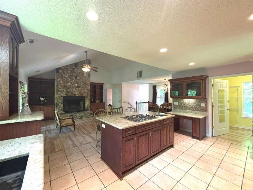 97 Hughes Drive, Maggie Valley, NC 28751.  MLS# CAR4239722, YatesRealty ID 21040. Upstair: Open concept Kitchen, living room and dining area. Great wood fire place.Pantry on the right.