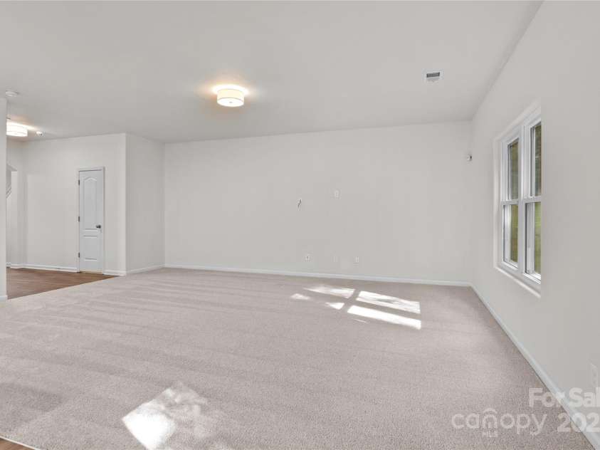 2532 Blue Moss Drive, Dallas, NC 28034.  MLS# CAR4271917, YatesRealty ID 21069. Great room provides open sight line to the foyer.   The open-concept design seamlessly connects to adjacent living areas, enhancing the flow and making it the heart of the home.