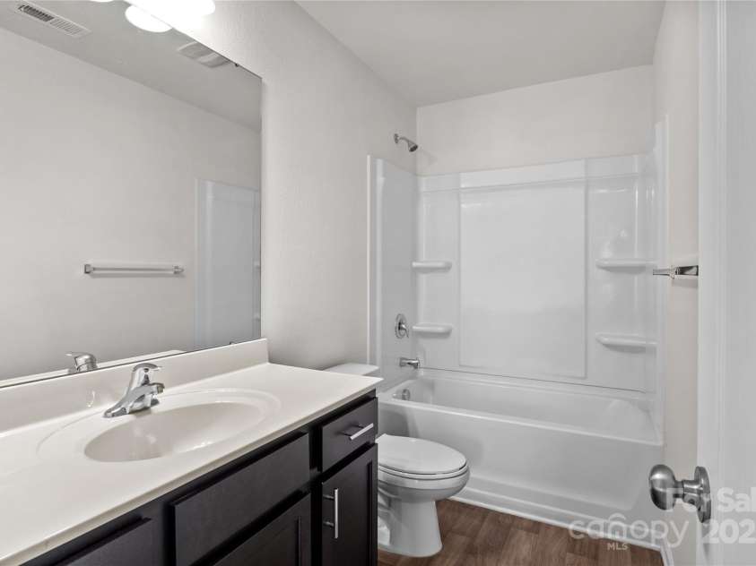 2532 Blue Moss Drive, Dallas, NC 28034.  MLS# CAR4271917, YatesRealty ID 21069. Hall bath on second floor: extended vanity, tub/shower combination, LVP flooring. Walls and ceiling freshly painted in June 2025.