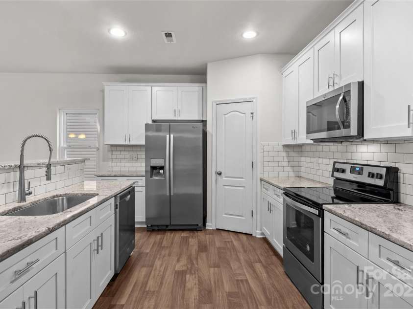 2532 Blue Moss Drive, Dallas, NC 28034.  MLS# CAR4271917, YatesRealty ID 21069. Kitchen features Whirlpool stainless steel appliances, including a never-used dishwasher. Refrigerator conveys with home.