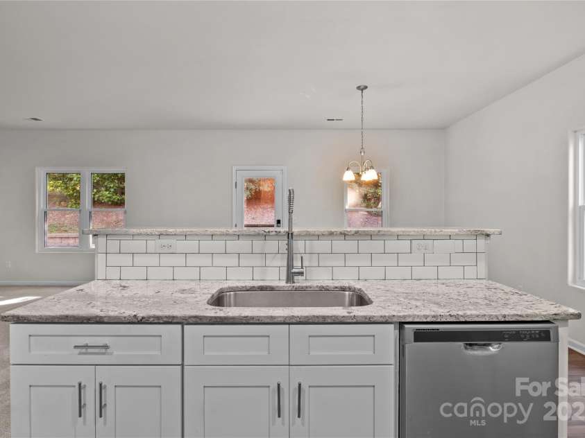 2532 Blue Moss Drive, Dallas, NC 28034.  MLS# CAR4271917, YatesRealty ID 21069. Kitchen provides open sight lines to the dining area and great room. Deep, undermount stainless-steel sink with  pull-out faucet.