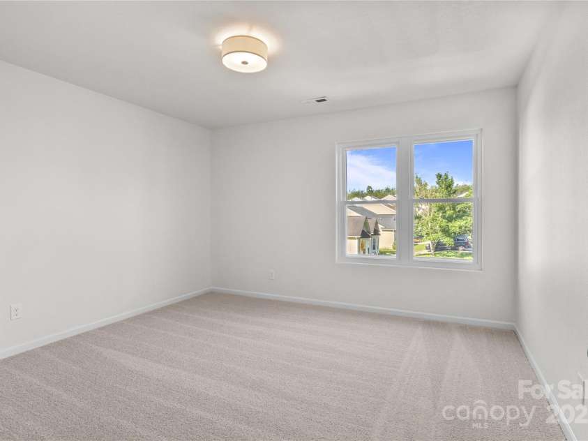 2532 Blue Moss Drive, Dallas, NC 28034.  MLS# CAR4271917, YatesRealty ID 21069. One of three additional bedrooms on second floor, featuring freshly painted walls and ceiling, brand new carpet and pad, new ceiling light fixture.