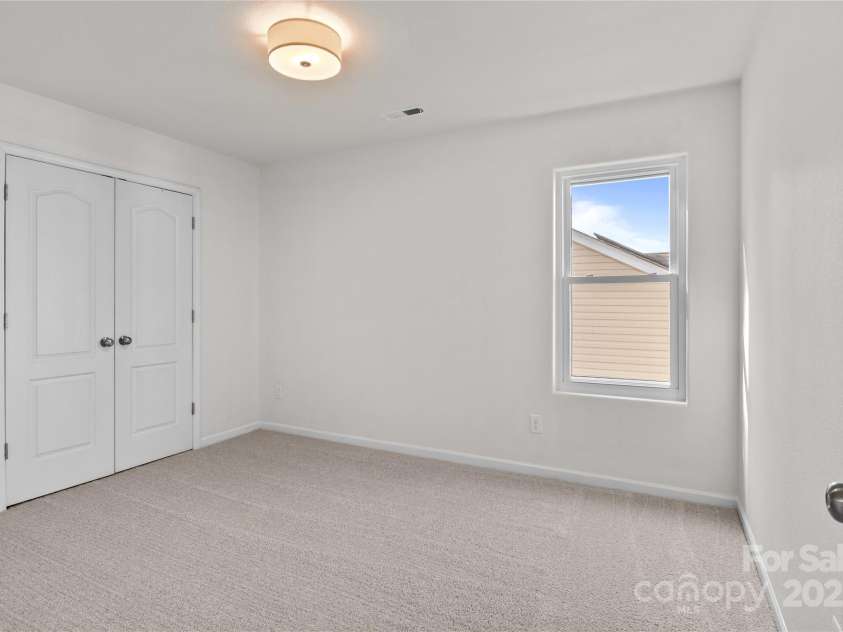 2532 Blue Moss Drive, Dallas, NC 28034.  MLS# CAR4271917, YatesRealty ID 21069. One of three additional bedrooms on second floor, featuring freshly painted walls and ceiling, brand new carpet and pad, new ceiling light fixture.
