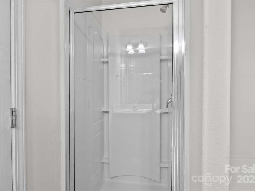 2532 Blue Moss Drive, Dallas, NC 28034.  MLS# CAR4271917, YatesRealty ID 21069. Separate, step-in shower in primary bathroom.