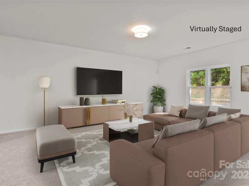 2532 Blue Moss Drive, Dallas, NC 28034.  MLS# CAR4271917, YatesRealty ID 21069. Spacious and inviting virtually staged great room featuring ample seating options for family and guests alike.