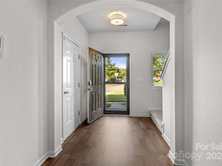 2532 Blue Moss Drive, Dallas, NC 28034.  MLS# CAR4271917, YatesRealty ID 21069. Spacious foyer with LVP flooring, new ceiling light fixture. Front door features retractable storm/screen door. Freshly painted walls and ceiling in June 2025.