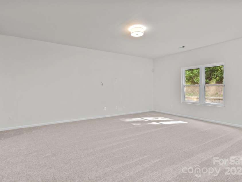 2532 Blue Moss Drive, Dallas, NC 28034.  MLS# CAR4271917, YatesRealty ID 21069. Whether you're hosting intimate get-togethers or entertaining a larger crowd, the spacious great room offers comfort and functionality to accommodate everyone with ease.