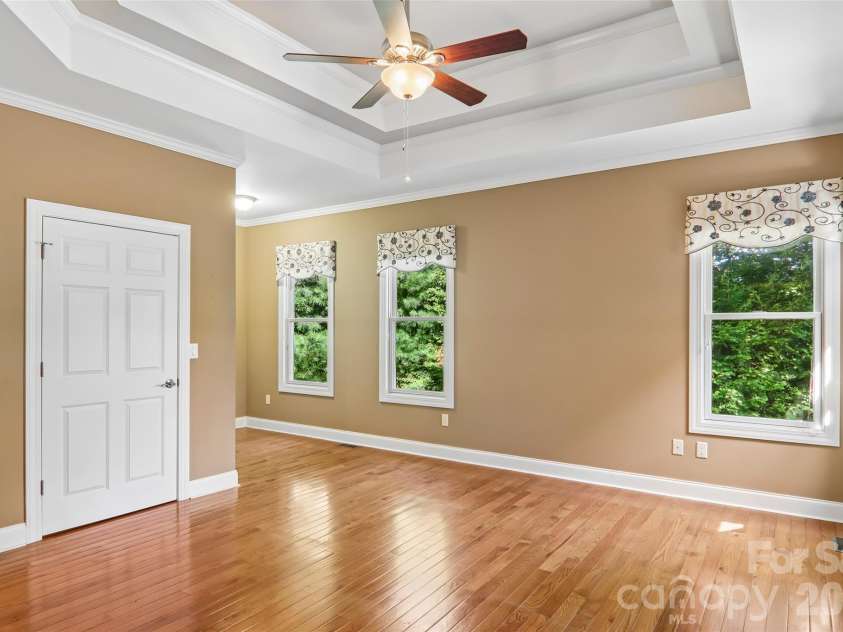 959 Silverglen Way, Hendersonville, NC 28792.  MLS# CAR4397996, YatesRealty ID 21071. Light-filled primary bedroom with tray ceiling