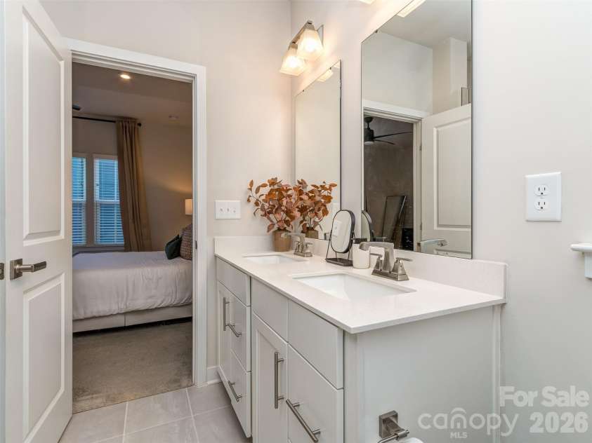 1033 Simcoe Lane, Charlotte, NC 28217.  MLS# CAR4358003, YatesRealty ID 21074. Primary Bathroom with Tile Flooring, Dual Vanity, & Walk-In Shower