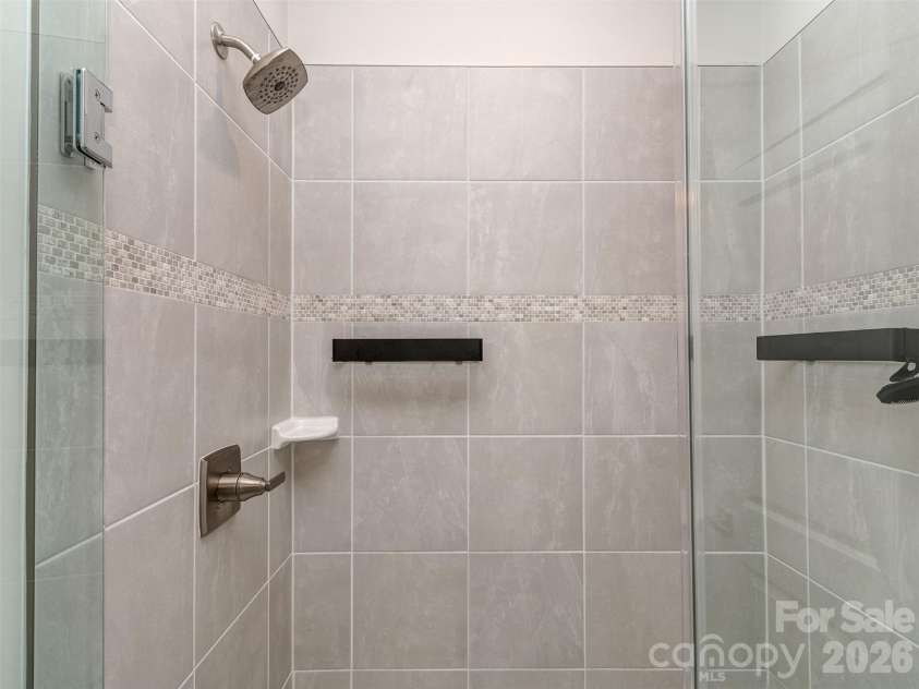 1033 Simcoe Lane, Charlotte, NC 28217.  MLS# CAR4358003, YatesRealty ID 21074. Primary Bathroom with Tile Flooring, Dual Vanity, & Walk-In Shower